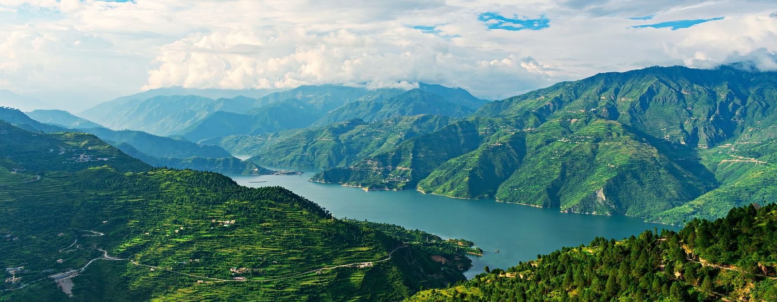 Picture featuring panoramic view of a Lake and mountains.