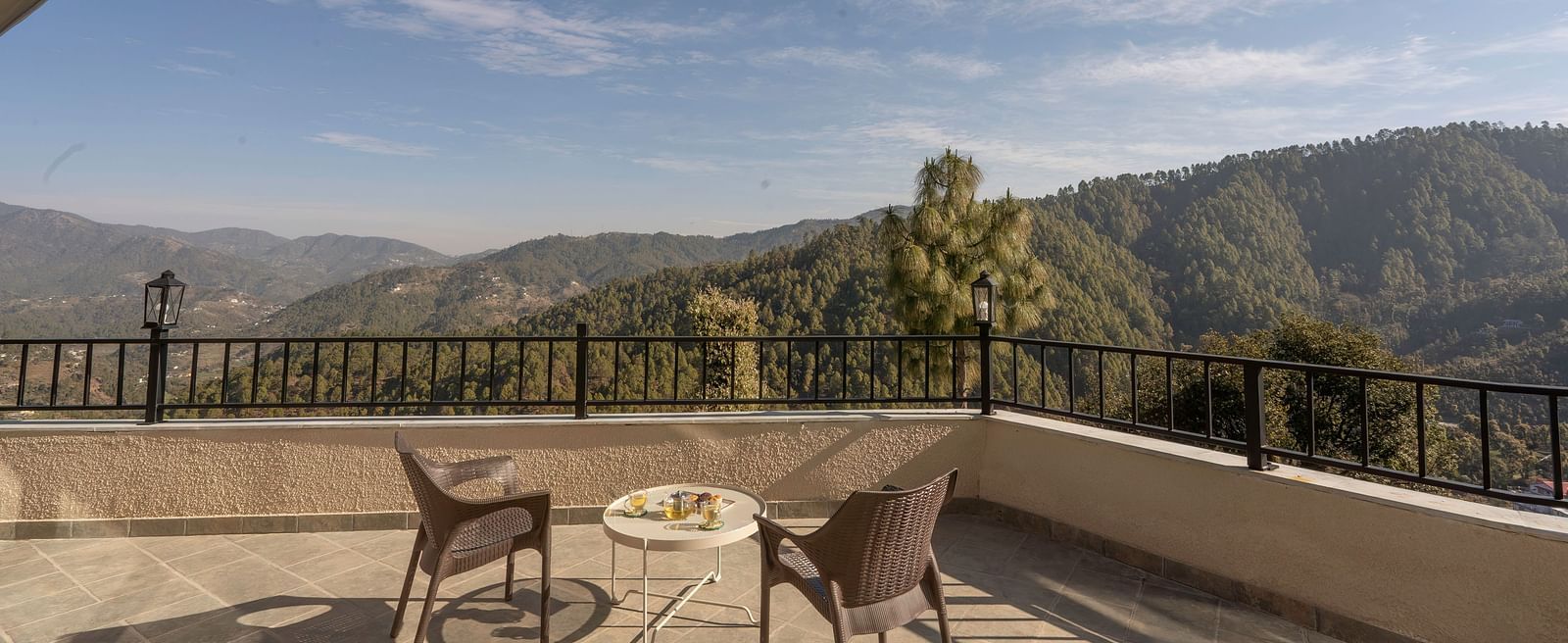 Spacious balcony with outdoor furniture and a mountain view at The Chamomile Estate.