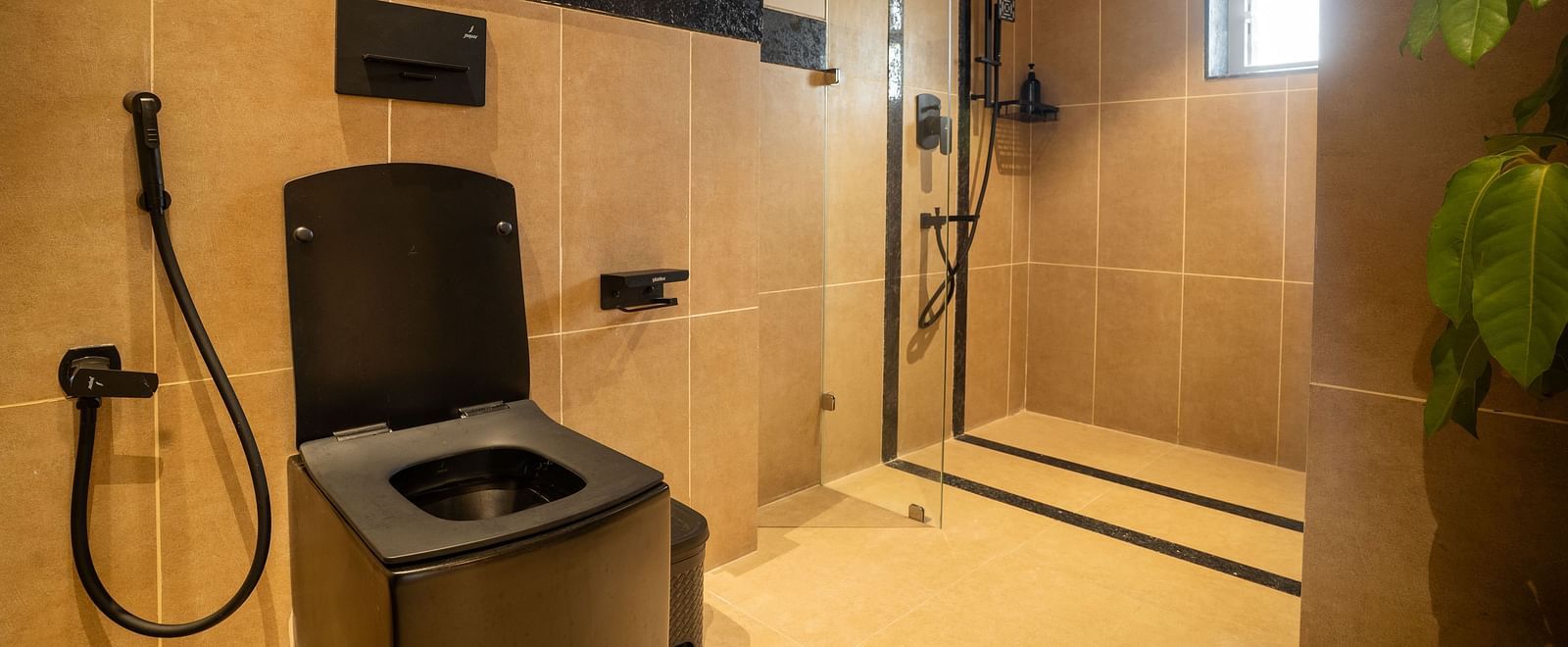 Modern bathroom with sleek black fixtures and a glass shower enclosure at Kssemya.