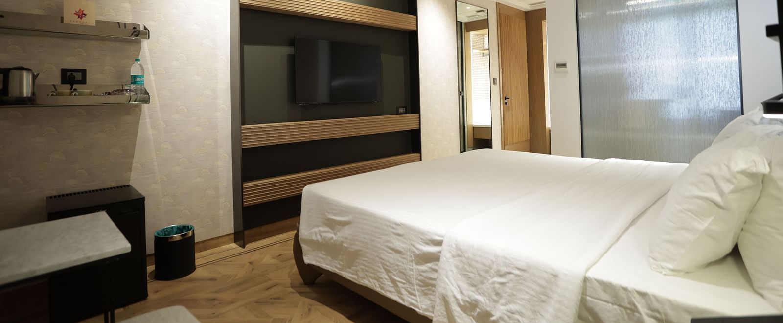 Premium accommodation at Regency Hotel, Mumbai featuring comfortable bedding, entertainment system, modern amenities and sophisticated interior design for guests.