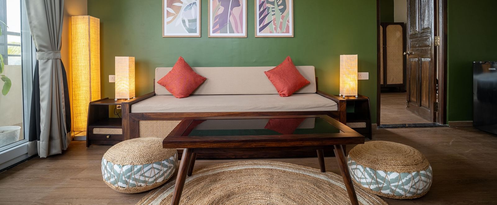 Chic living area with a wooden coffee table, pouffes, and contemporary wall art at Kssemya.