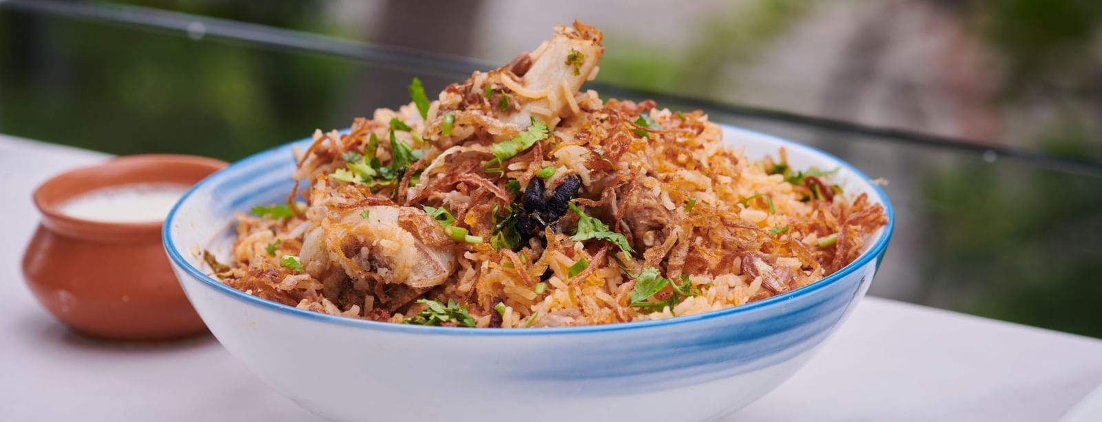 A bowl of biryani served with salad on the side at Grande Bay Resort & Spa.