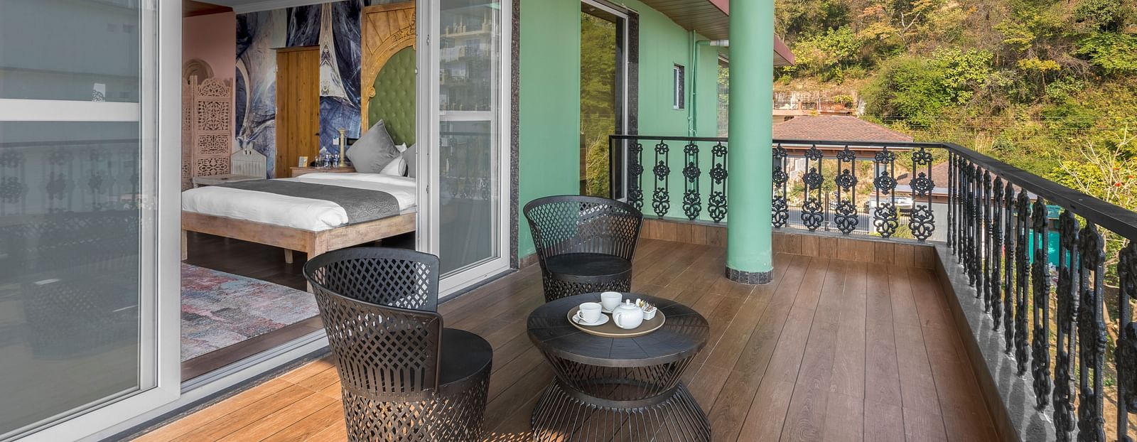 a balcony with a small table and chairs for sitting - Atman, Dharamshala
