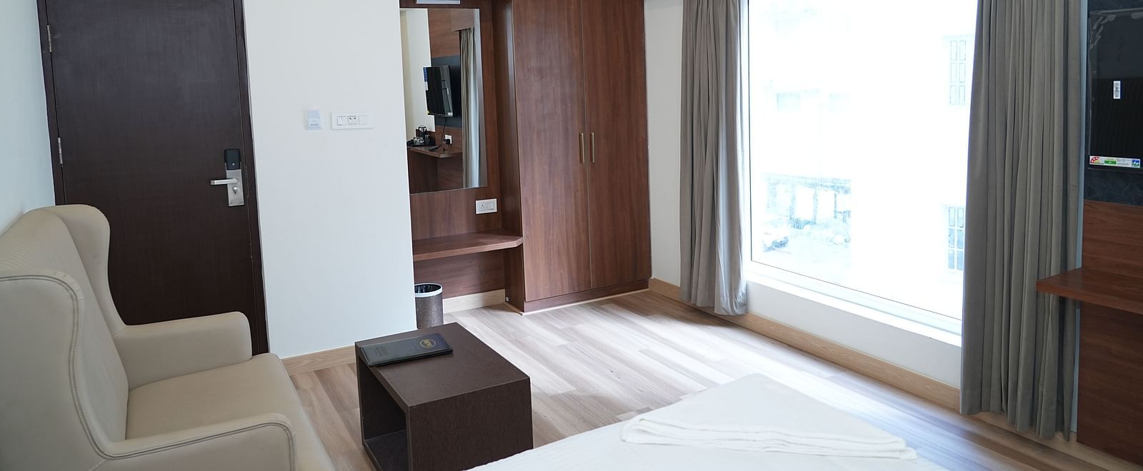a top view shot of the premium executive room featuring a huge window with ample natural light coming into the room - Hotel Grand Sigma