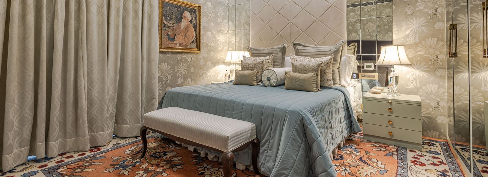 image of the spacious bedroom with plush bedding and long window curtains at our heritage luxury suite with whirlpool - The Claridges New Delhi