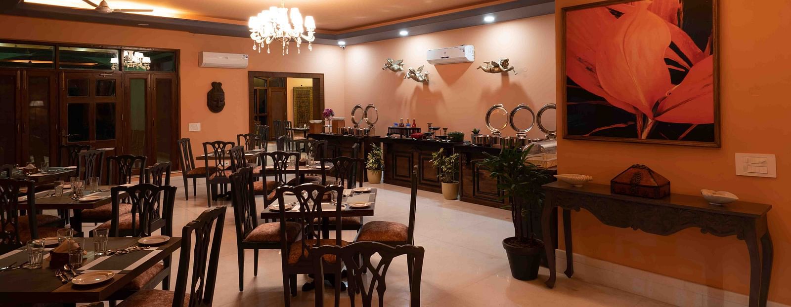 An image of  modern restaurant interior of Atman, dharamshala with stylish furniture and artwork.