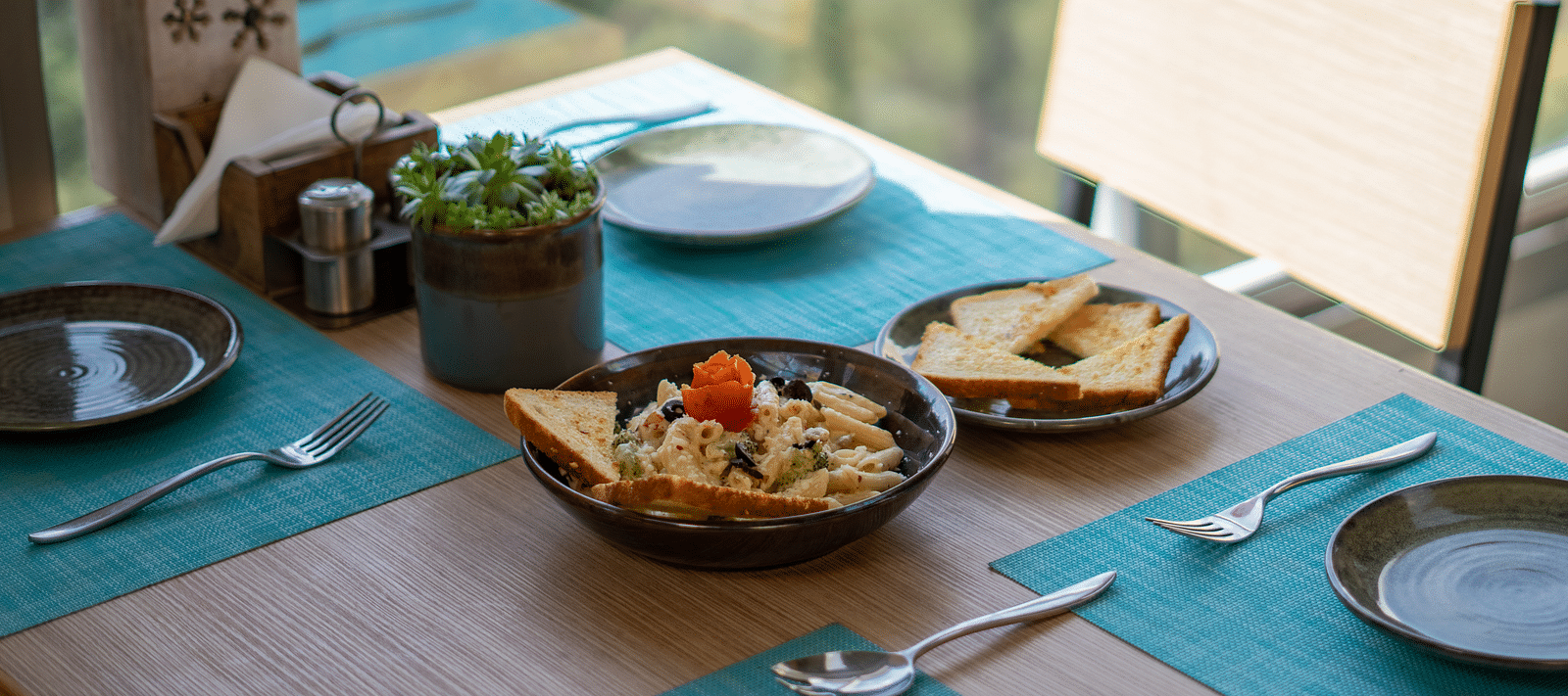 A dish placed on a table with cutlery arranged beside it at BluSalzz Escapade Resort, Lansdowne