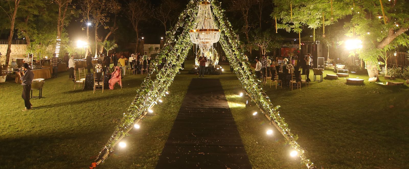 Lawn decorated with lights and canopy setup for a night event at Tisya Farms, Gurgaon.