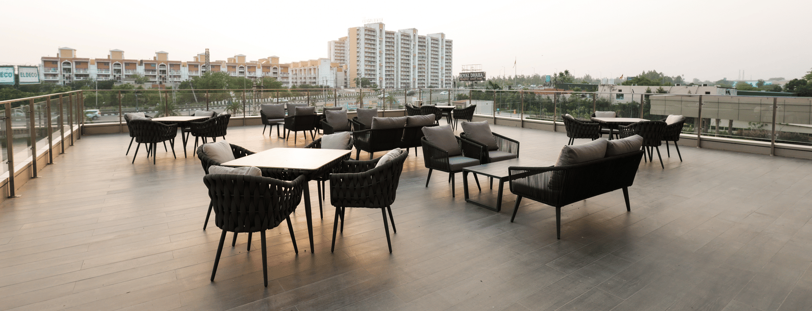 Rooftop seating with city views and modern dining setup at Ramada by Wyndham Sonipat Murthal