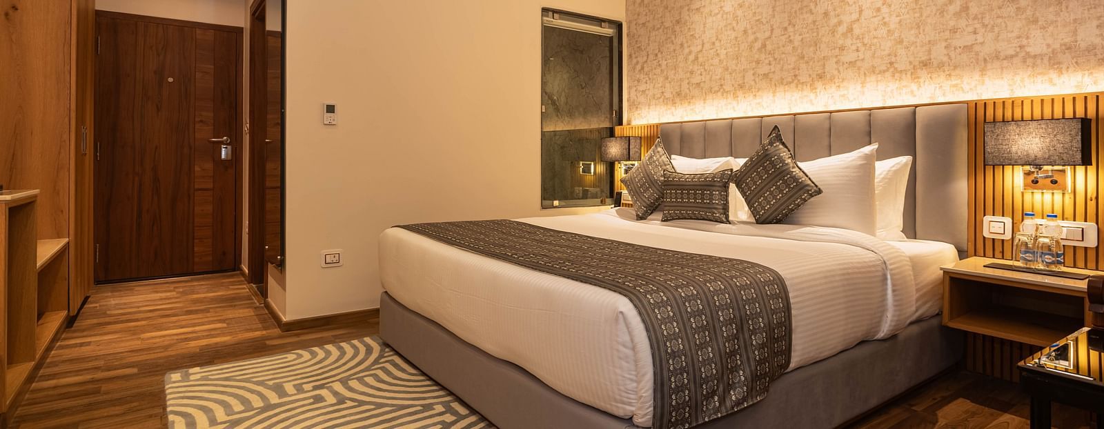 An image of a Family Room with a bed, bed side table, lamps, and rug - The Belvedere Himalayan Retreat, McLeodganj