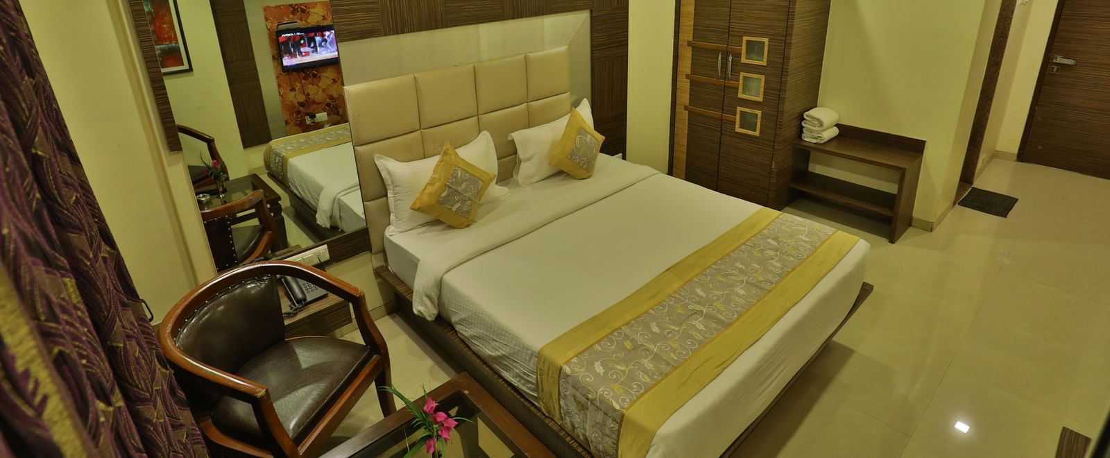 An expansive view of a well-appointed hotel room featuring a bed, seating, and contemporary decor - Retreat Heritage, Lonavala