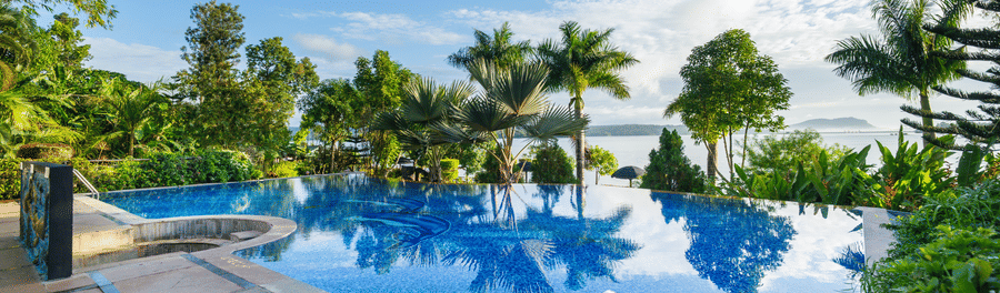 Image of a swimming pool with trees surrounding it at Coorg Jungle Camp Backwater Resort, Kushalnagar.