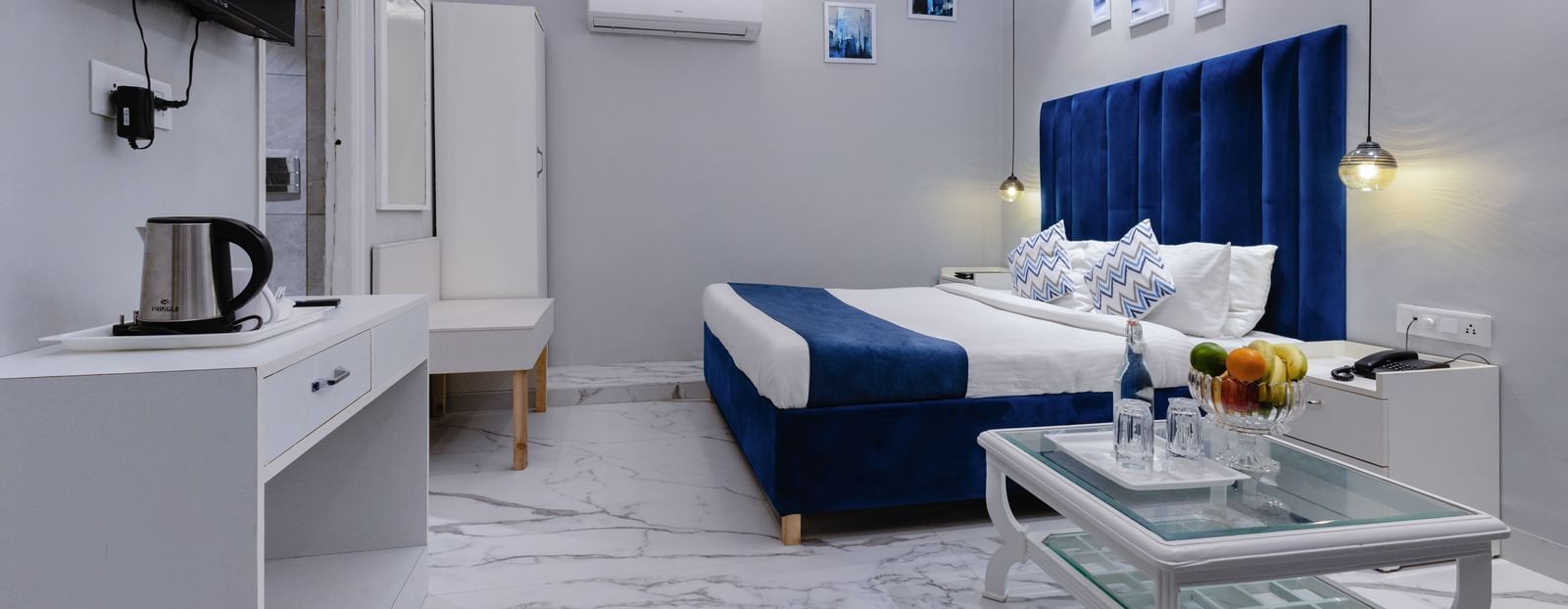 Cosy hotel room at Hotel Downtown17, Chandigarh with a flat-screen TV, sofa, and artistic accents.