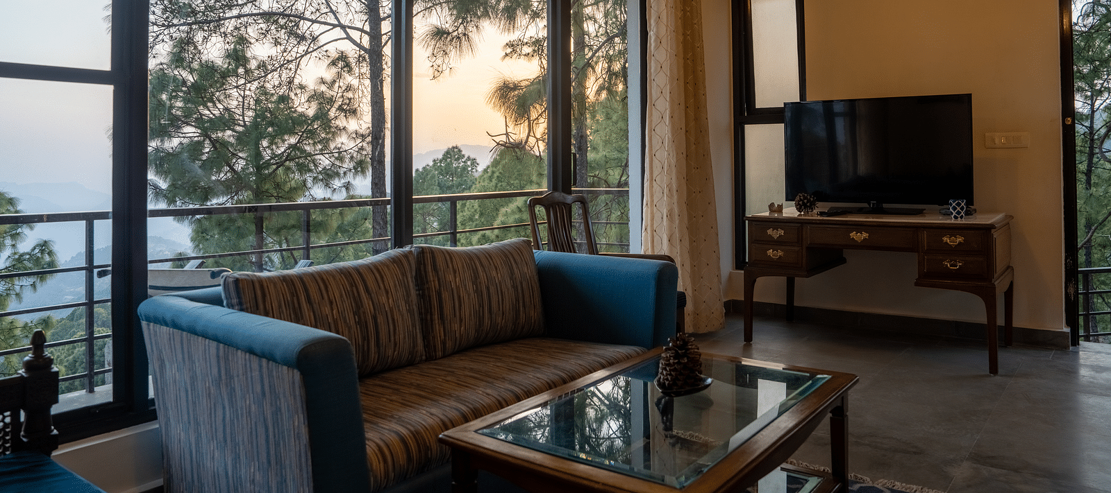 A suite living room with a television placed on the table at BluSalzz Escapade Resort, Lansdowne.