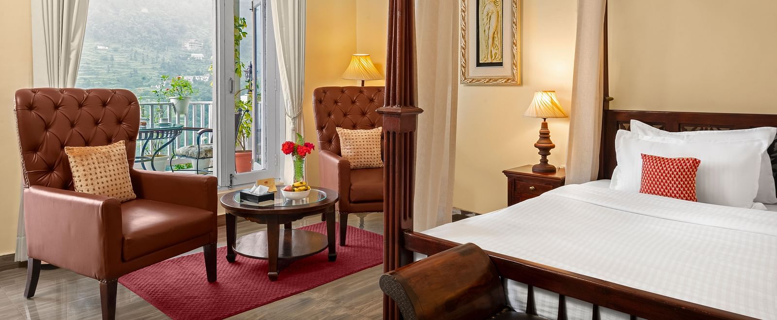 Elegant bedroom with a cosy seating area and a mountain-view balcony at BluSalzz Collection - Suvaasa Resort, Ramgarh.