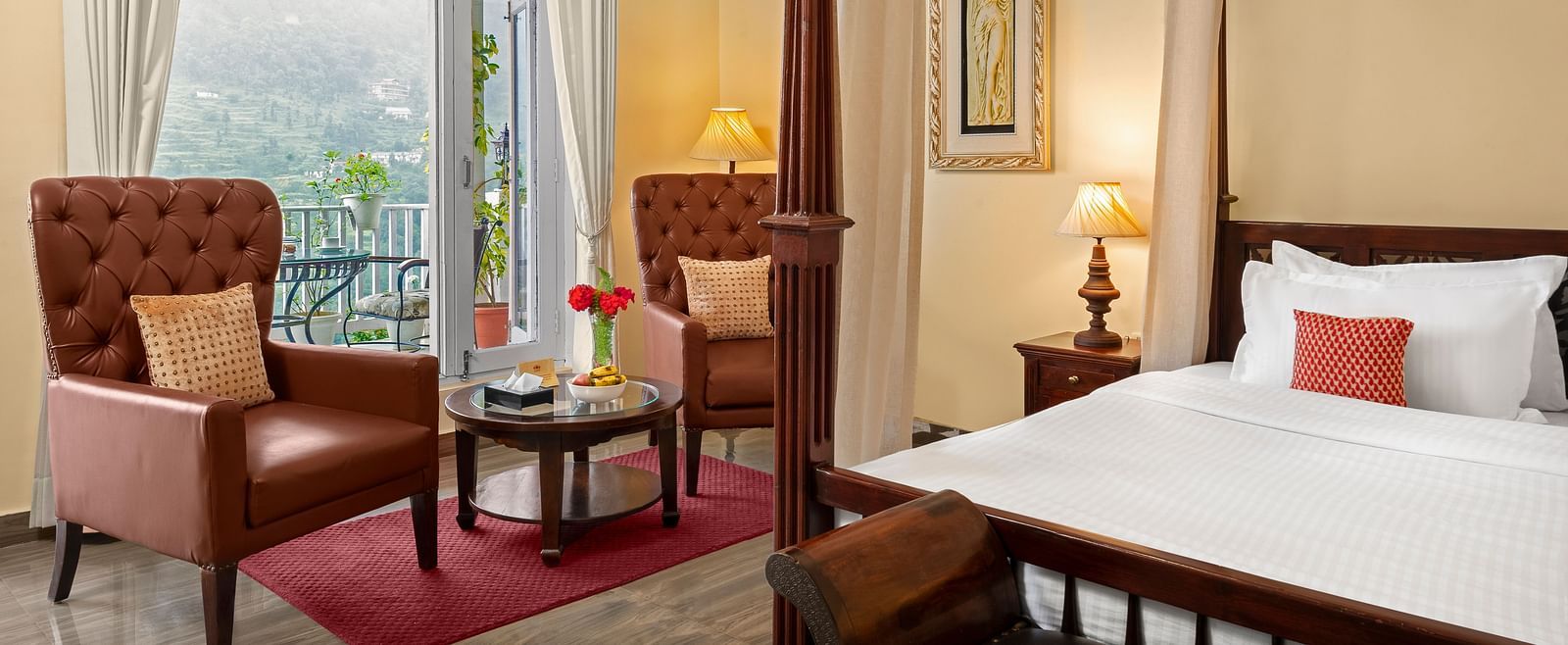 Elegant bedroom with a cosy seating area and a mountain-view balcony at BluSalzz Collection - Suvaasa Resort, Ramgarh.