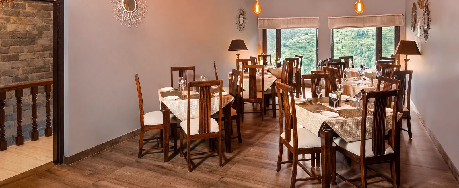 Rustic indoor dining area with wooden furniture and sloped ceiling, at BluSalzz Collection - Suvaasa Resort, Ramgarh.
