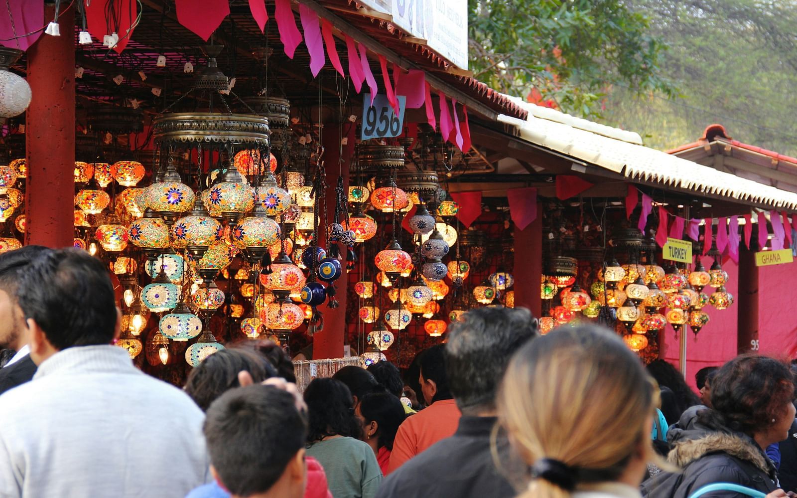 An overview of a Mela with people thronging towards the shops