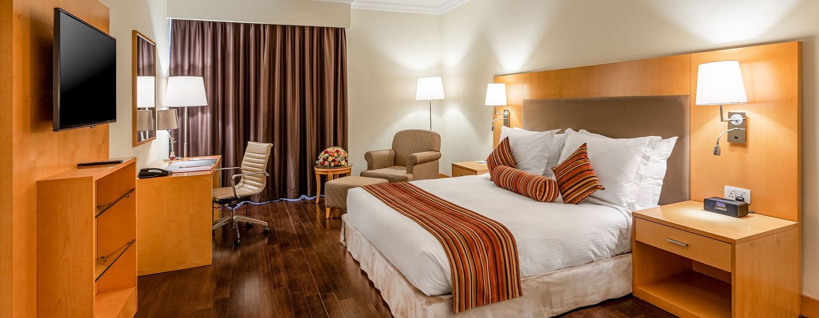 An overview of a room with a double bed, side tables and lamps - Ramada by Wyndham Addis, Addis Ababa