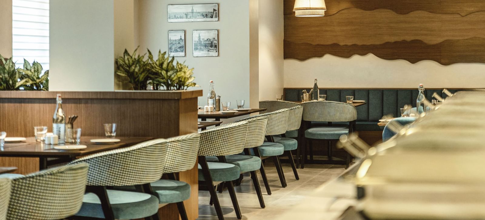A wide shot of the restaurant at Mango Hill Central, Chennai, showing dining tables and chairs.