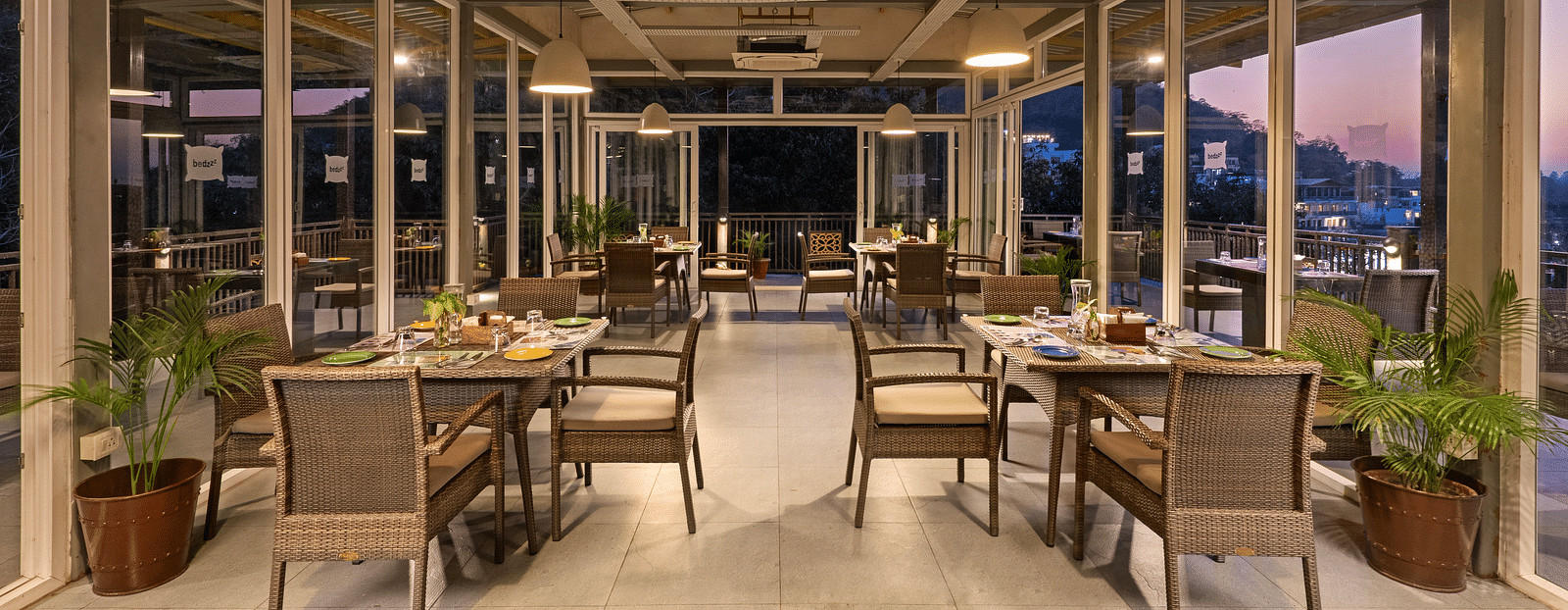 Dining area with air conditioner, featuring elegant decor and ambient lighting at Bedzzz, Rishikesh