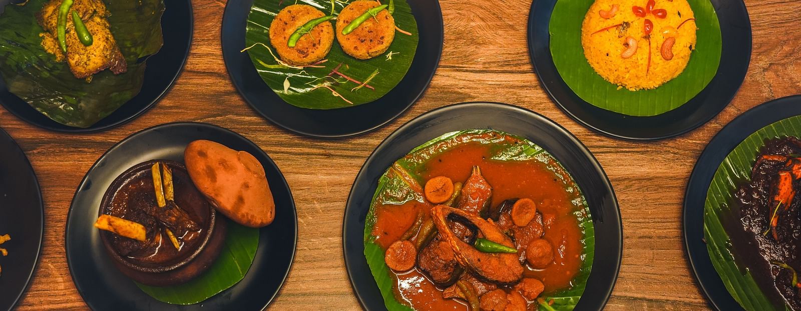 a wide spread of authentic bengali cuisine featuring various dishes on the table - Dip Holidays, Birbhum