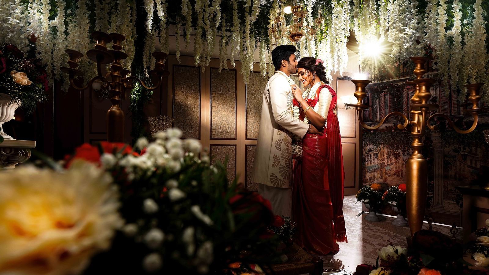 Couple getting married where the groom is kissing the bride's forehead at Grand Chennai By GRT Hotels. - Best Hotel near US Consulate Chennai