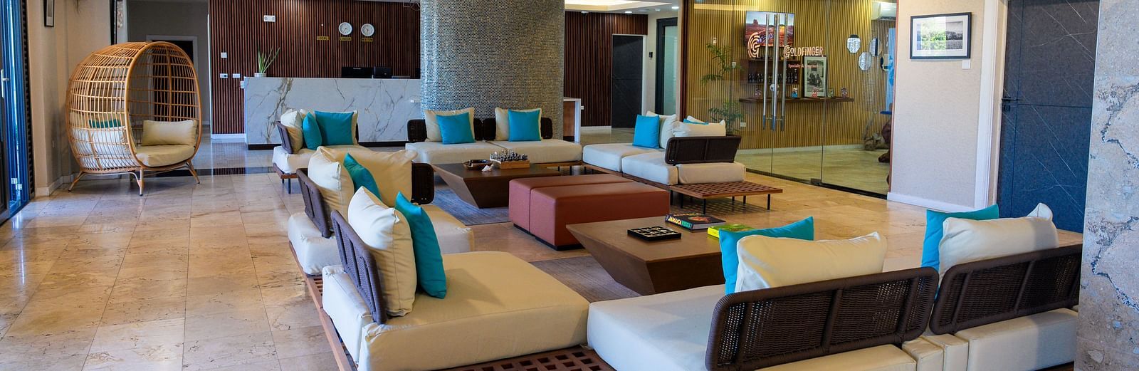 An overview of a hotel lobby in Montego Bay featuring ambient lighting, cosy and contemporary looking sofas placed around a table - Hotel 39, Jamaica (Montego Bay)