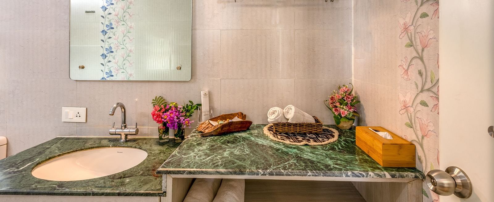 overview of the bathroom with the sink area in view inside one of the rooms - neer ganga resorts