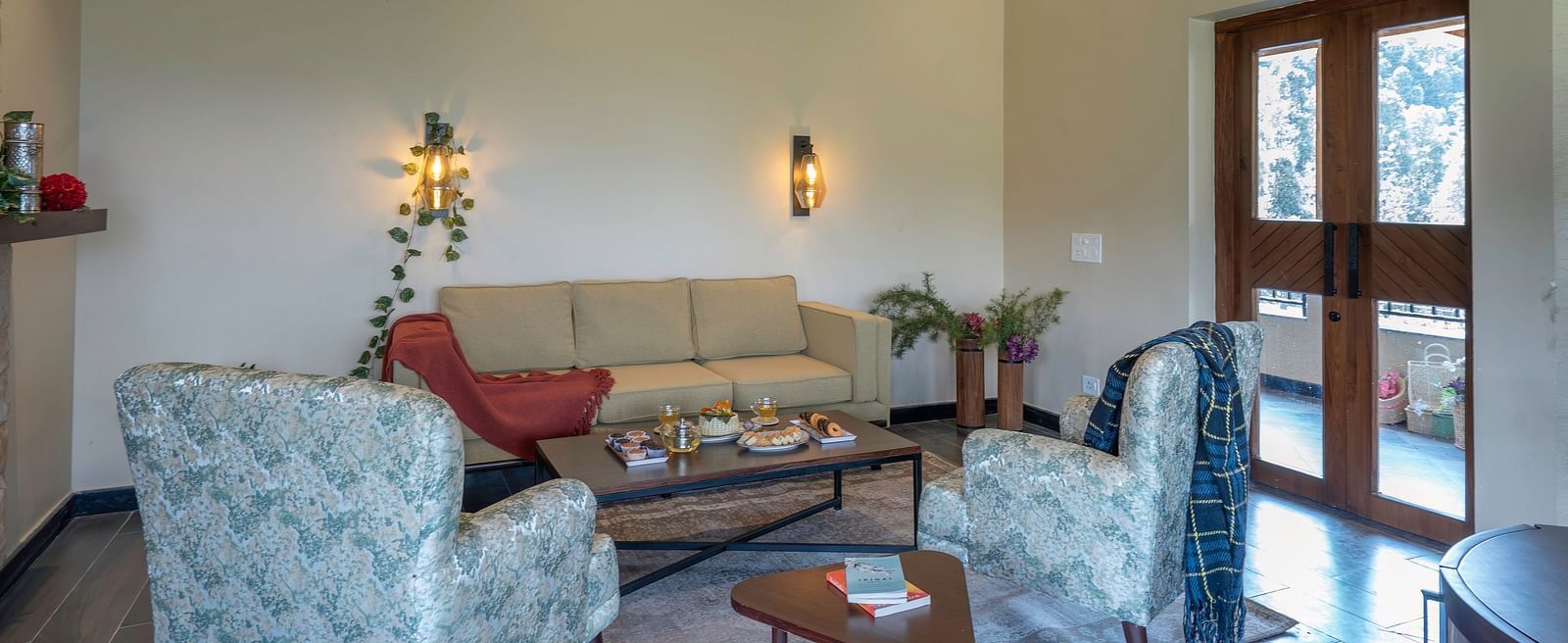 Bright and airy living room with comfortable seating and large windows at The Chamomile Estate.