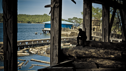 A view of beach from underneath a bridge during a day | Barefoot at Havelock