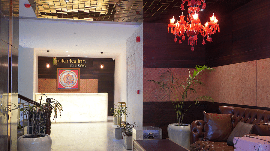 Lobby featuring a reception desk and sitting space above which a chandelier is hanging