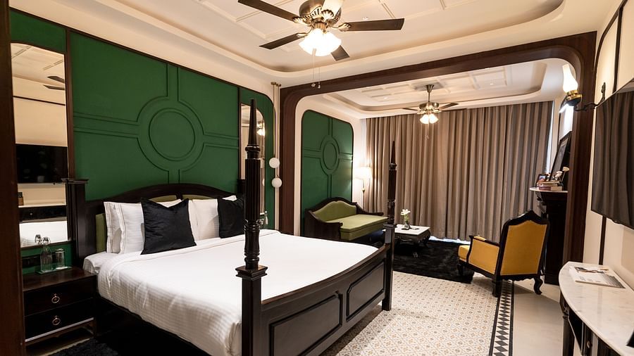 An image of a bedroom with king size bed, flat TV screen, chair, and sofa - Polo Orchid Resort, Cherrapunjee