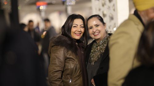 An image of two women smiling at an event at Heritage Village Resorts & Spa