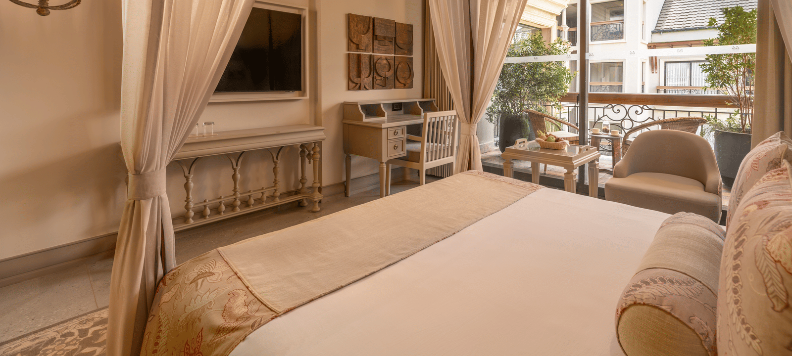 Corner view of the Premium Room featuring a double bed and wall-mounted television at The Evren, Vagator.