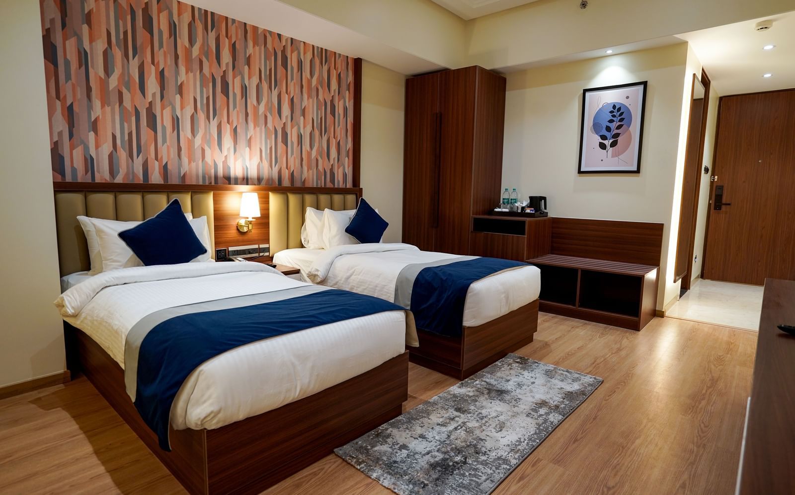 Corner view of the Superior Twin Bed Room with 2 single beds along with a rug in front of it at M2 Square by Monday Premium.
