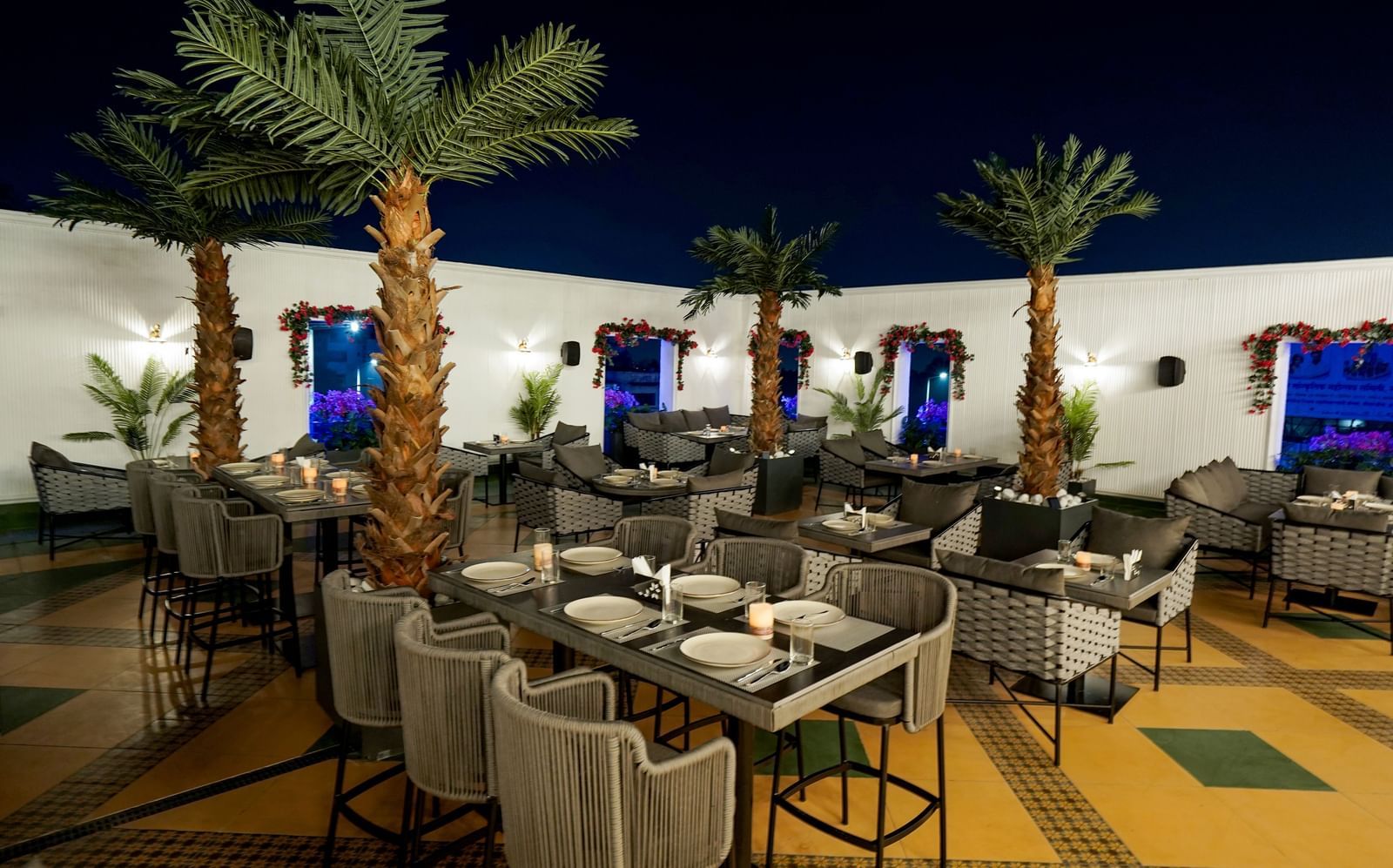 Corner view shot of the Sky Roof featuring well arranged dining tables along side several trees at M2 Square by Monday Premium.