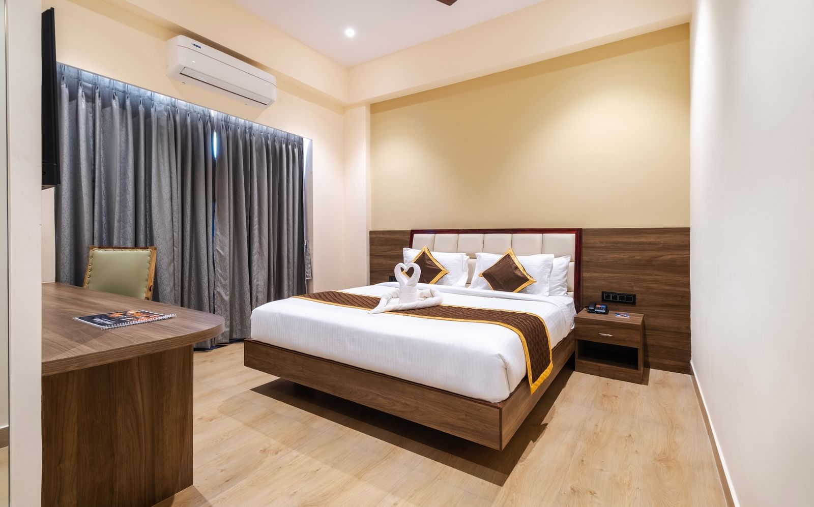 Spacious room at Monday Hotels Amalapuram Heights with elegant interiors and air-conditioning.