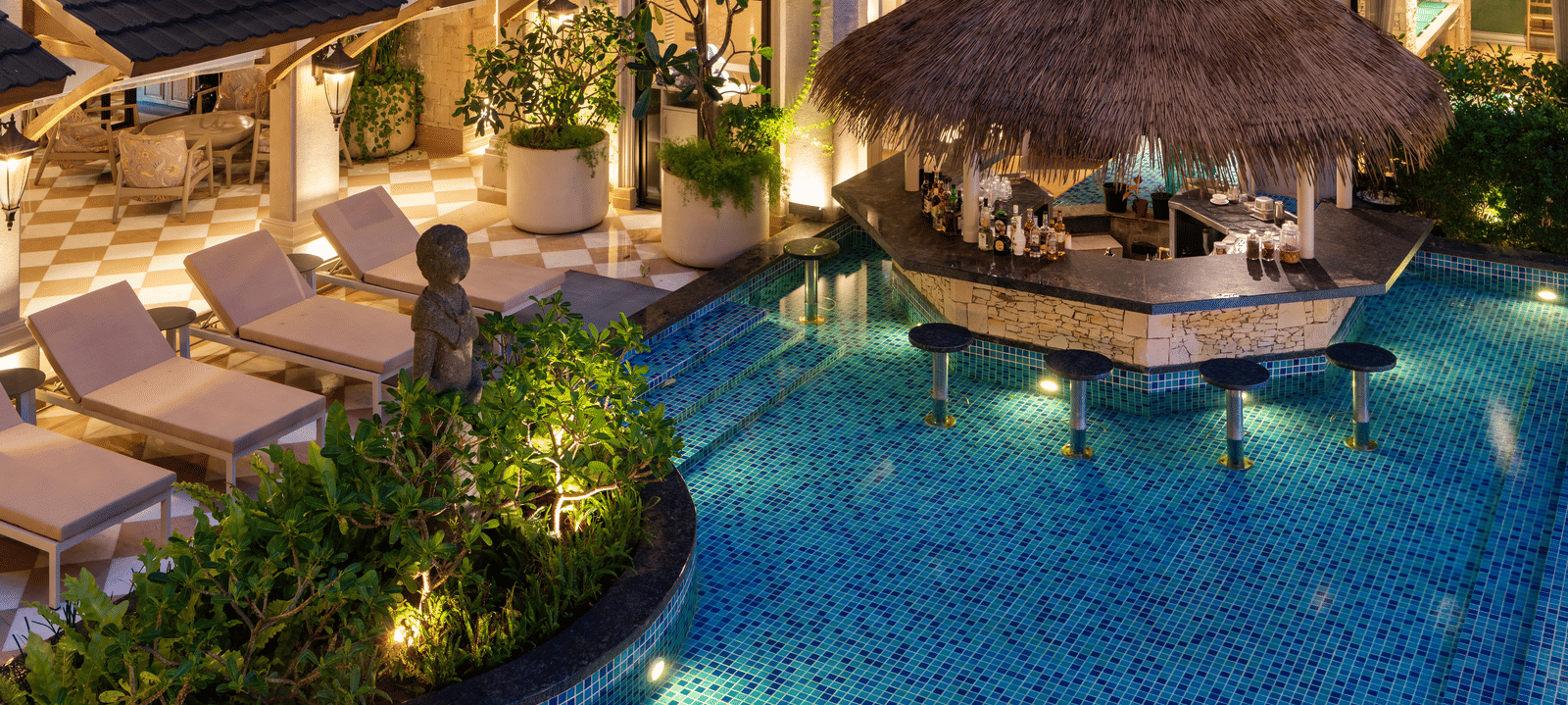Close-up shot of the Splash Pool Bar featuring a pool-side bar counter cover with thatched roof at The Evren, Vagator.