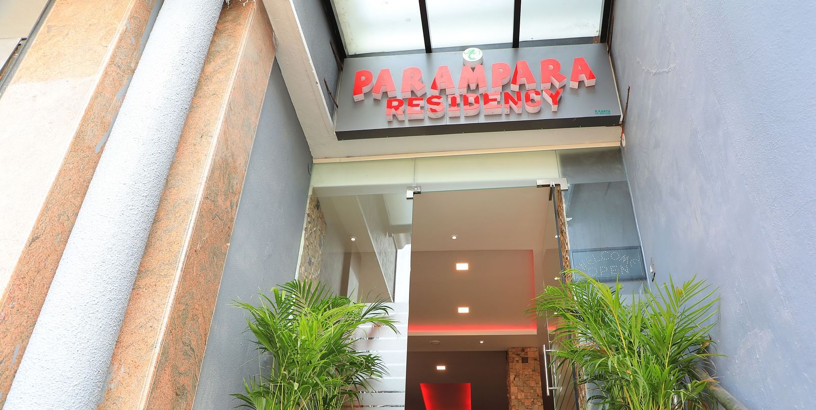 Facade of Parampara Residency, Kushalnagar Town with Parampara Residency written above the entrance.