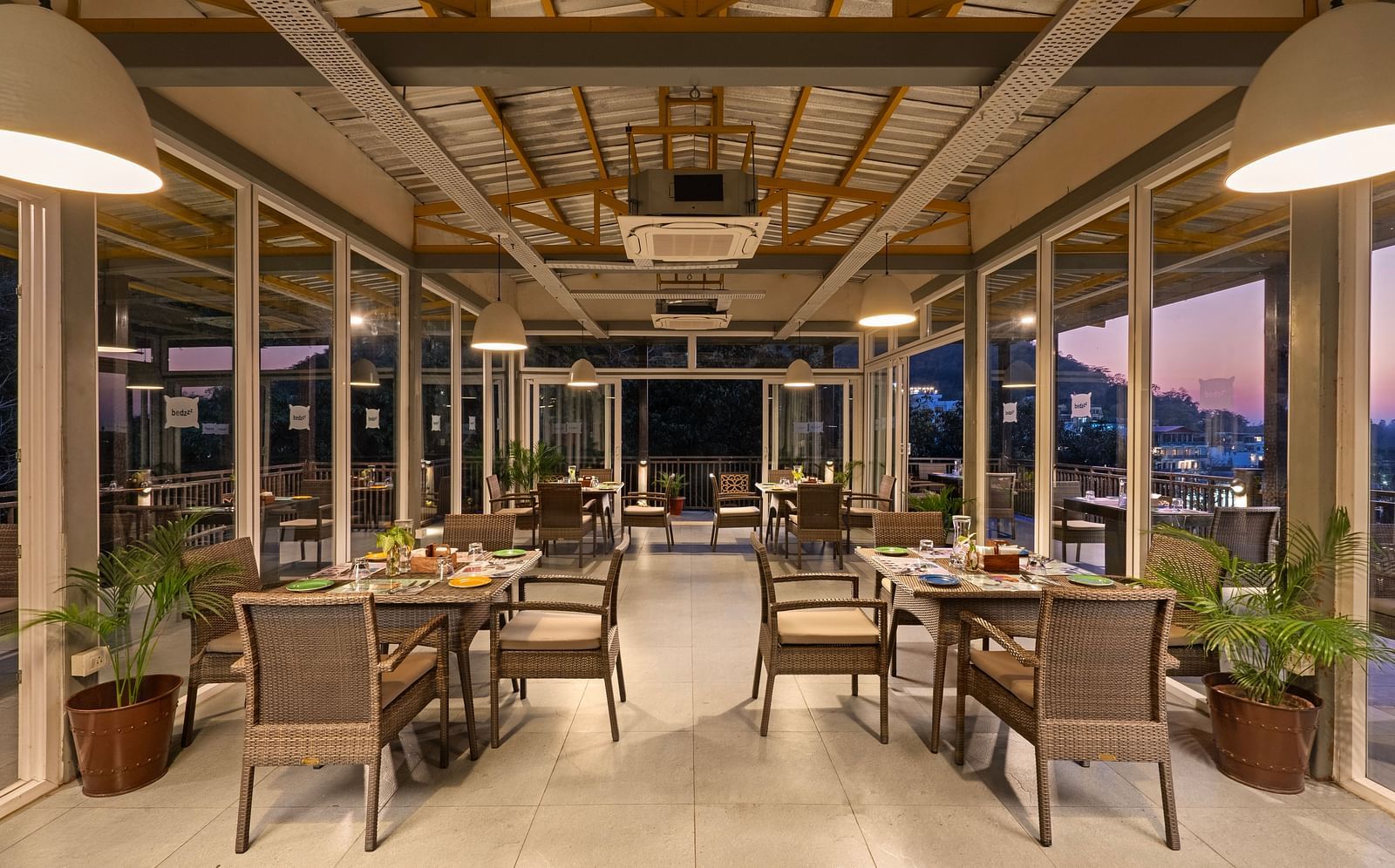 Dining area with air conditioner, featuring elegant decor and ambient lighting at Bedzzz, Rishikesh