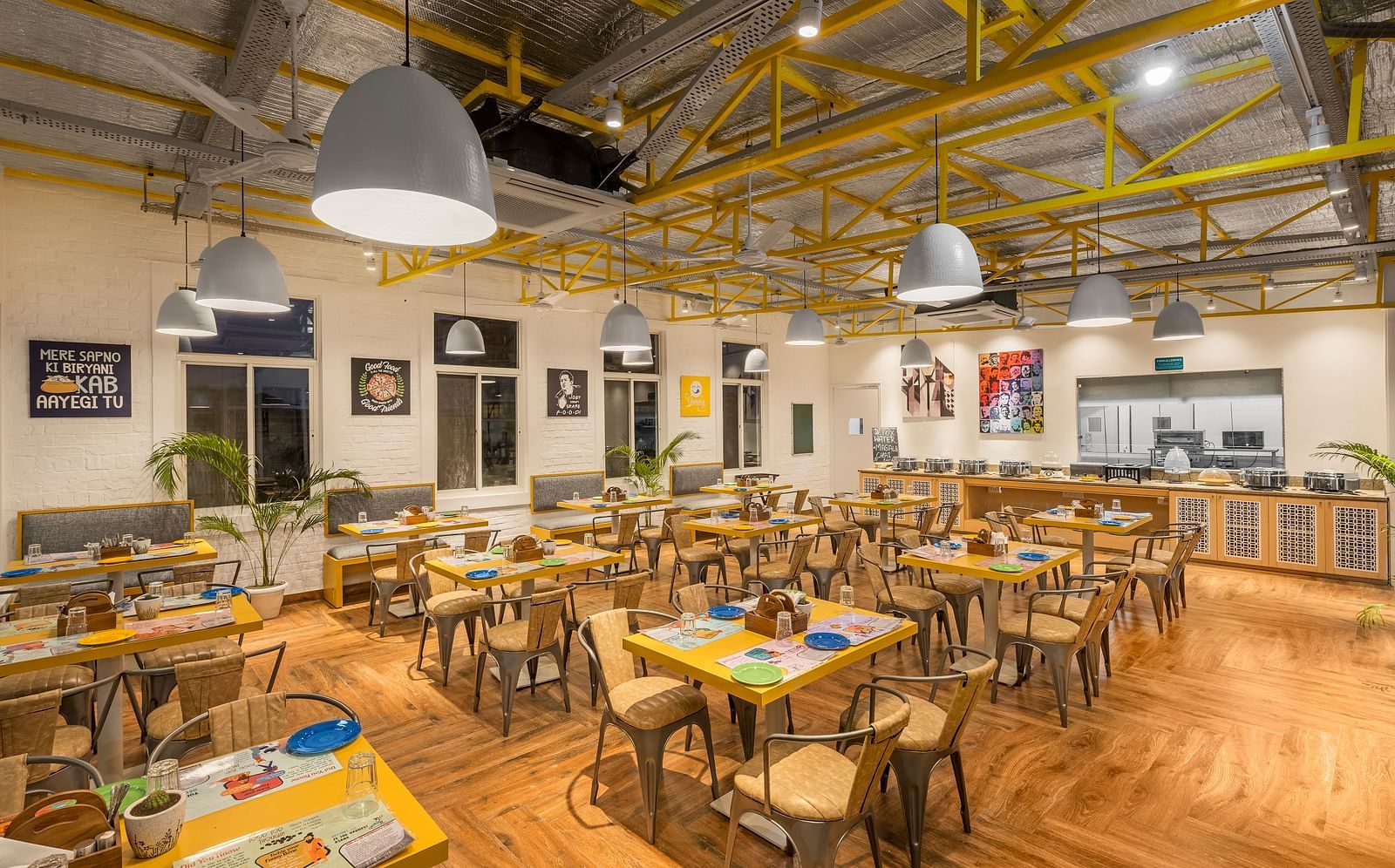 An image of a café interior featuring multiple tables set with menus and plates, chairs for dining, and the place is well lit.