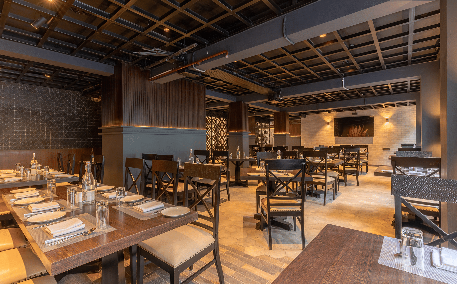An image of a dinning area with wooden interior designs and table seating at Bedzzz Xclusiv Ikshana Luxe