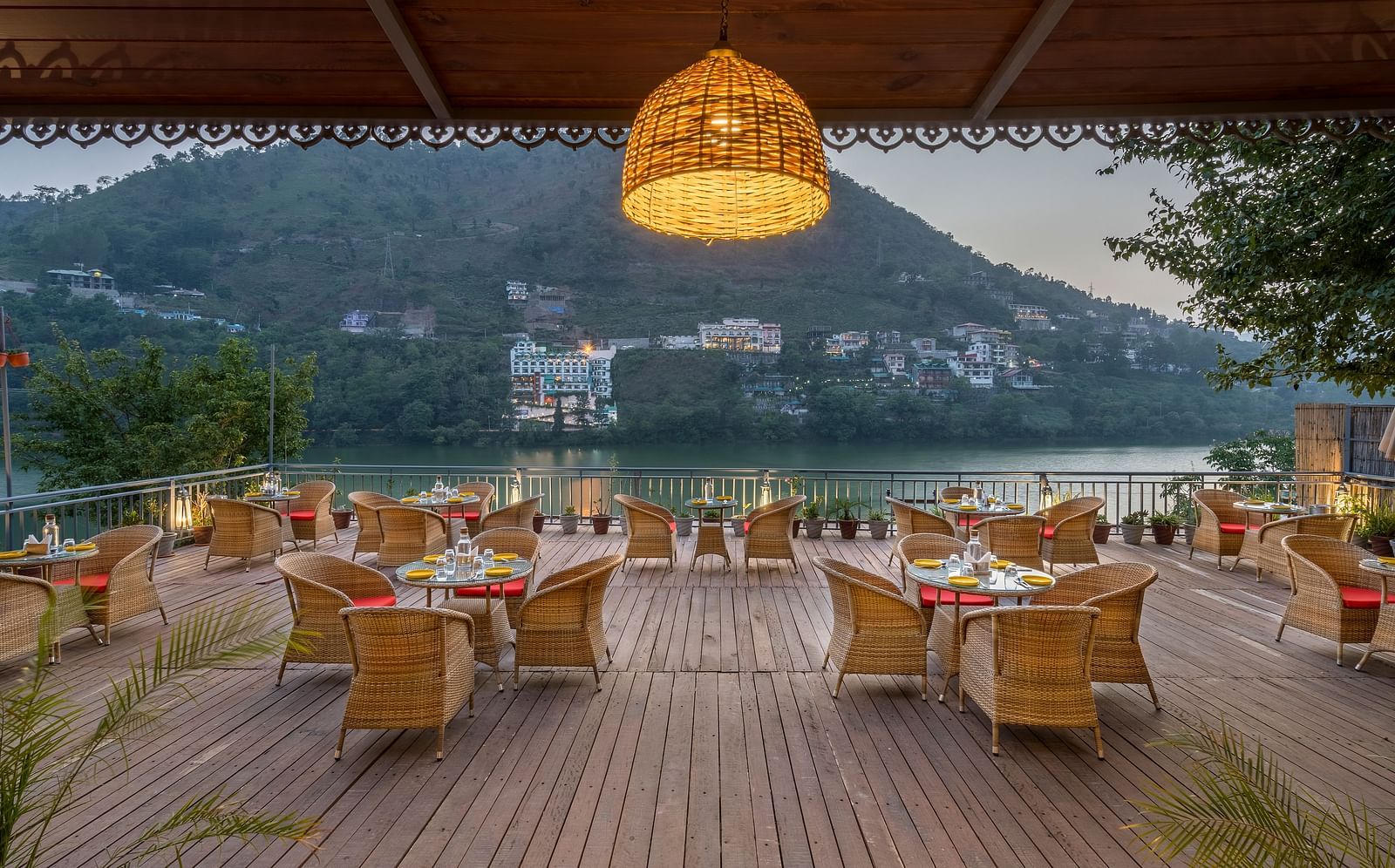 Wide angle shot of L-attitude deck with a beautiful lake and mountain view at Fishermen's Lodge, Bhimtal 