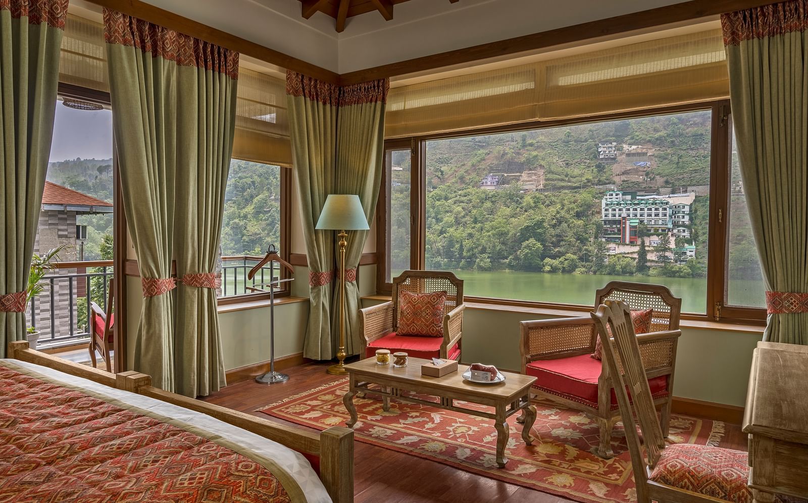 A cozy and royal sitting area in the Superior Lake Facing Rooms at Fishermen's Lodge, Bhimtal, offering stunning views of the lake.