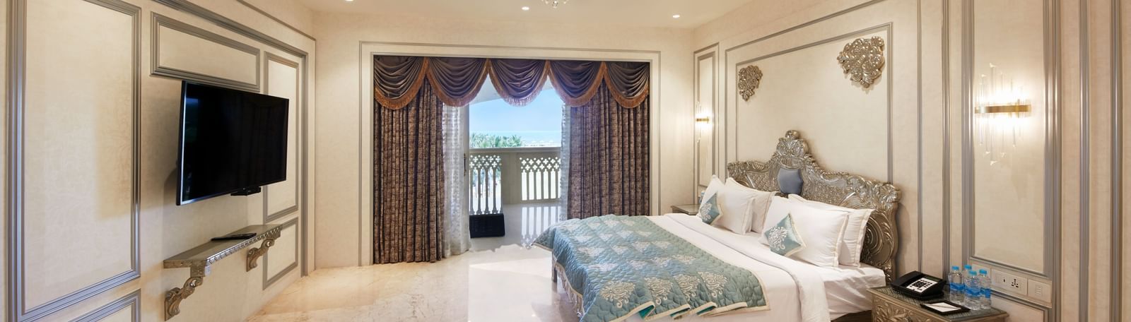 An elegant bedroom in our Villa with a patterned ceiling, modern furnishings, and a cosy balcony – Kaldan Samudra, one of the top resorts in ECR