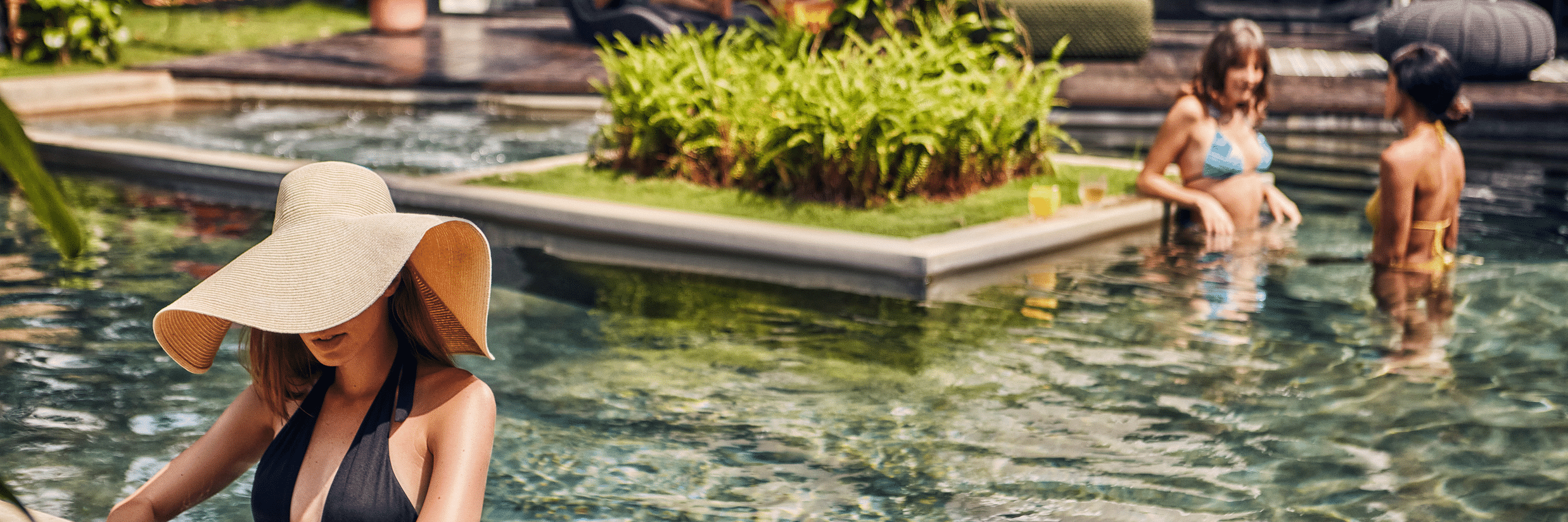 People relaxing in the clear waters of the Goa villa with private pool at Villa in Palms by V Escapes