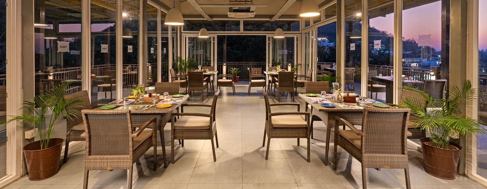 Dining area with air conditioner, featuring elegant decor and ambient lighting at Bedzzz, Rishikesh