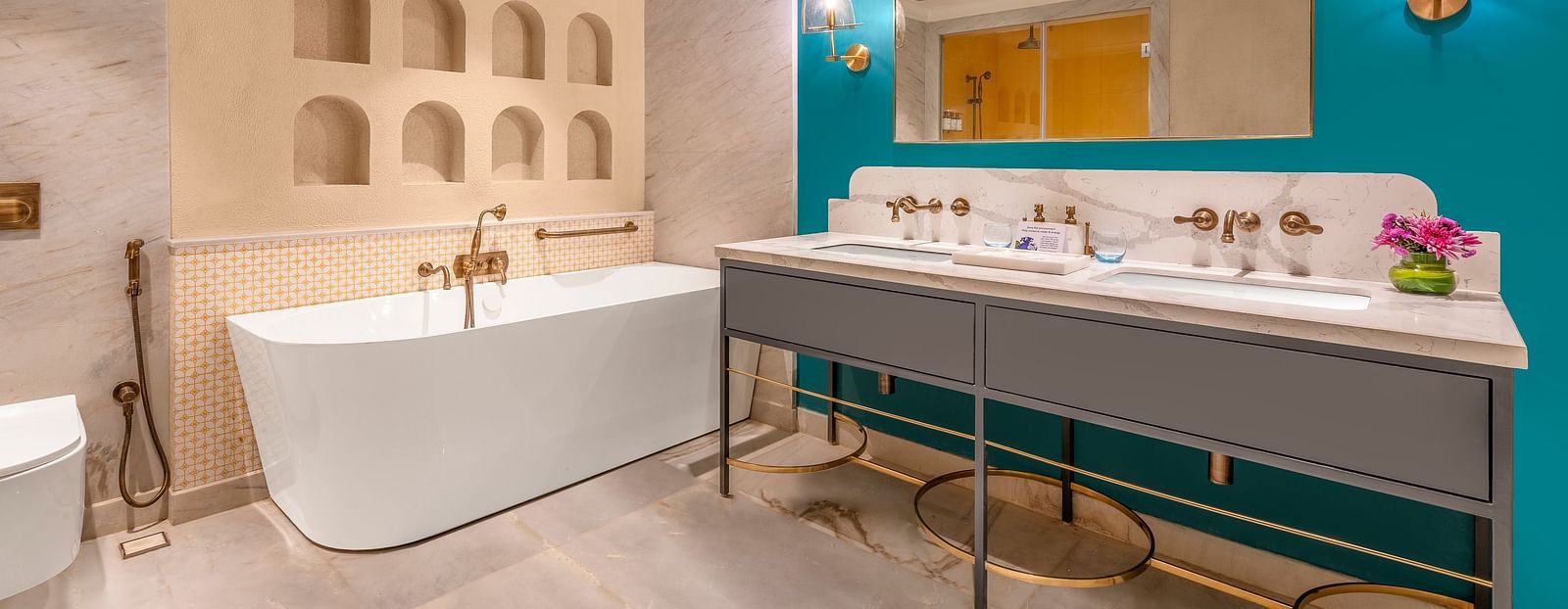 An image featuring a luxurious bathroom with a freestanding bathtub, a double vanity, and a large mirror.