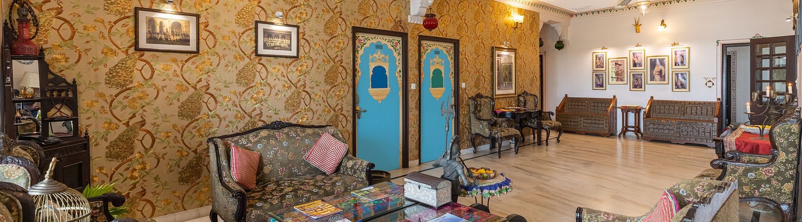 Lobby at Panna Vilas Palace showcases cushioned furniture and a wooden table, enhanced by warm and inviting lighting | Panna Vilas Udaipur